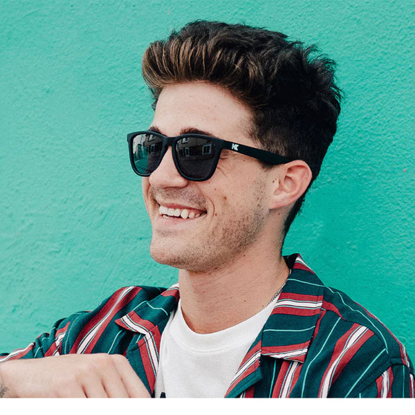 Man wearing Knockaround Black Smoke Classics Sunglasses