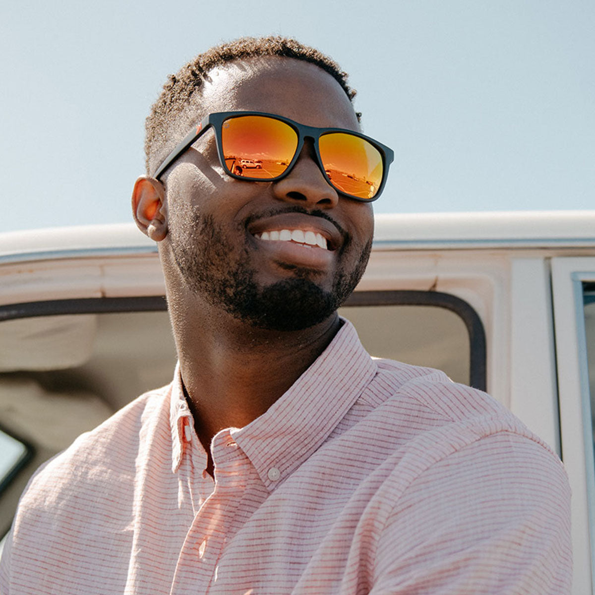 Man wearing Knockaround Matte Black Red Sunset Fast Lanes Sunglasses