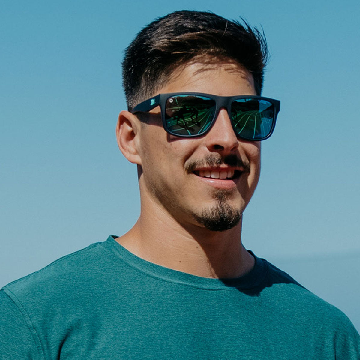 Man wearing Knockaround Rubberized Navy Mint Torrey Pines Sport Sunglasses