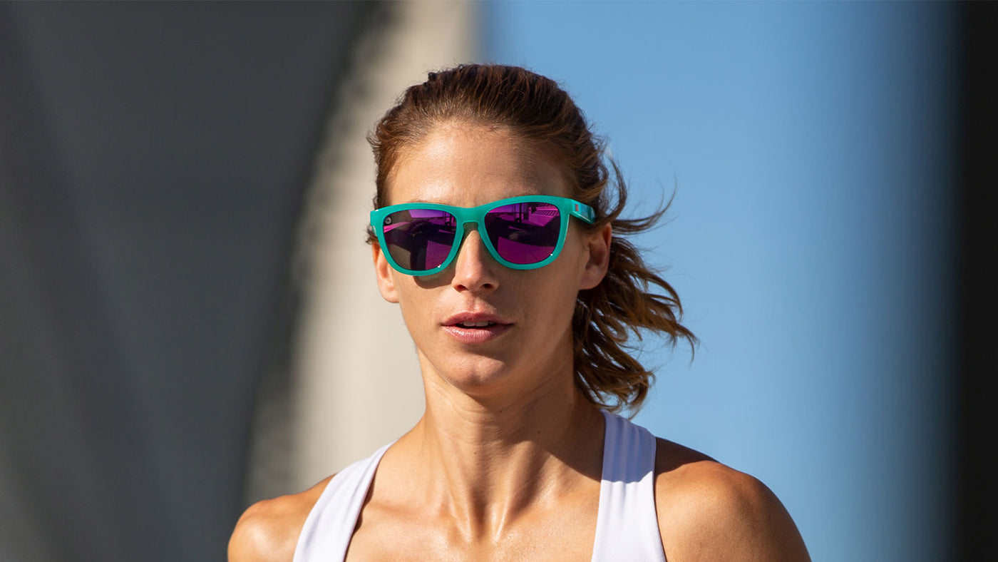 Woman wearing aquamarine fuschsia premiums sports sunglasses