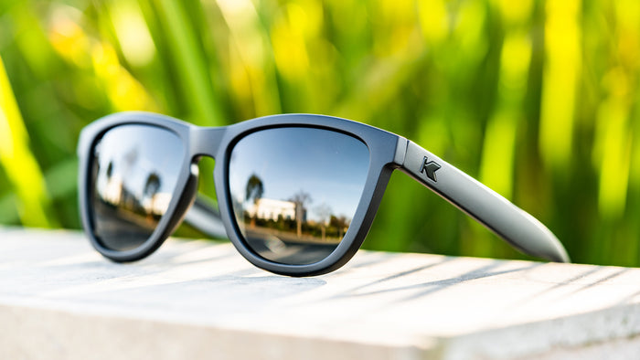 Lifestyle photo of Black on Black Premiums Sunglasses