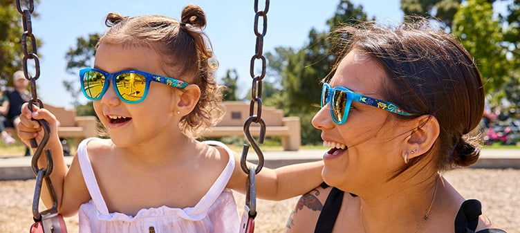 Mother and daughter in a park wearing SpongeBob SquarePants sunglasses by Knockaround