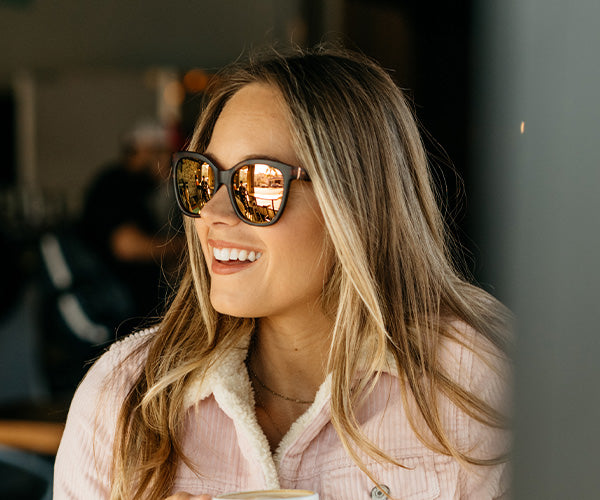 Woman wearing Matte Tortoise Shell / Rose Gold Deja Views sunglasses in the fall