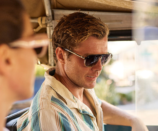 Man wearing Cortado Pacific Palisades sunglasses sitting inside a vehicle 