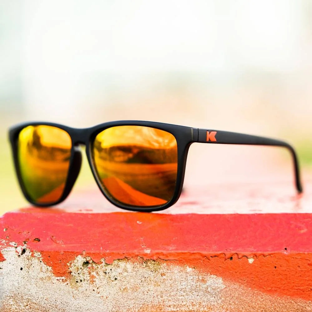 Lifestyle photo of Matte Black / Red Sunset Fast Lanes Sunglasses