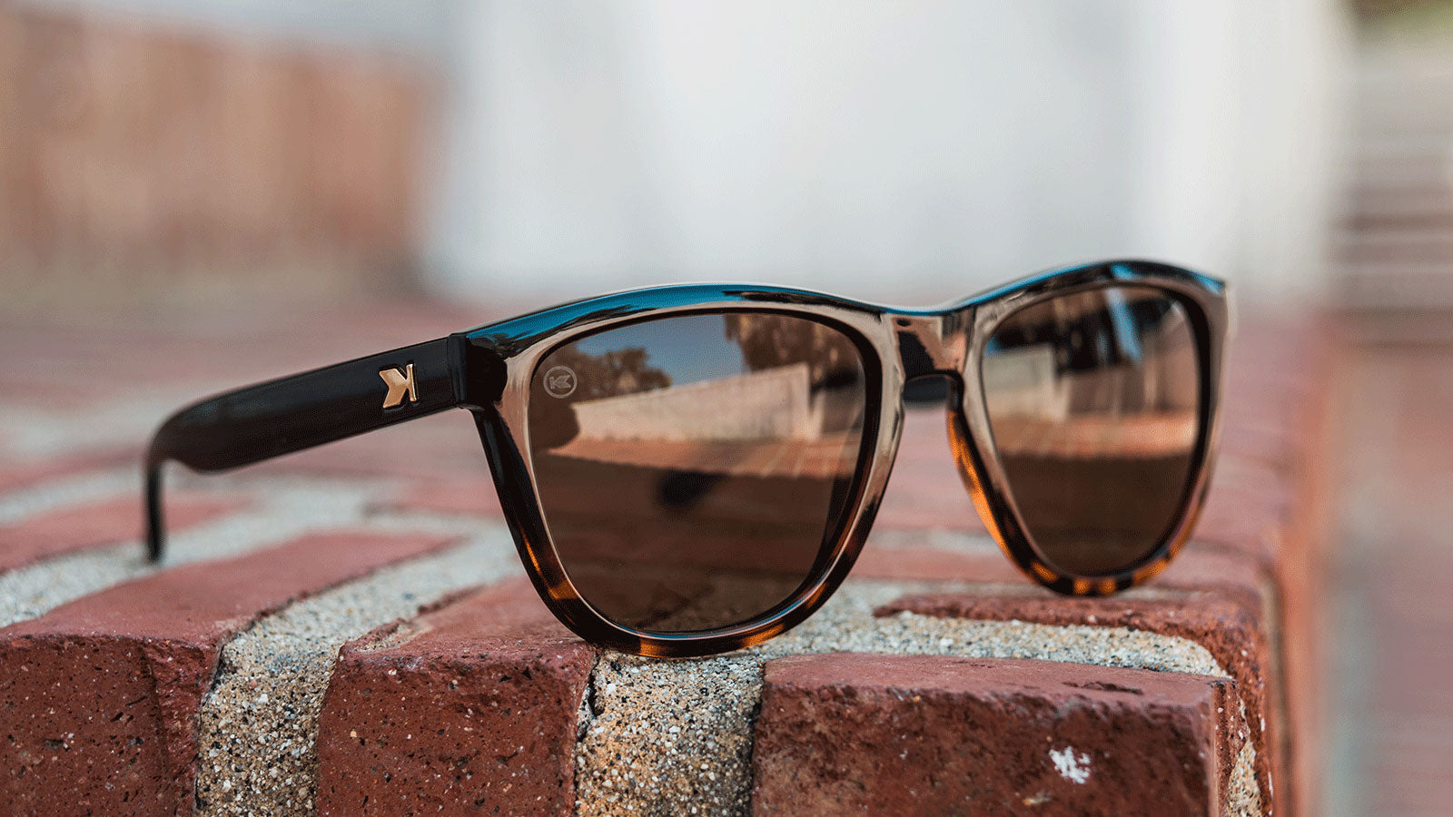 Lifestyle photo of Glossy Black and Tortoise Shell Fade / Amber Premiums Sunglasses