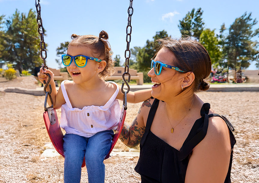Mother and daughter in a park wearing matching SpongeBob SquarePants sunglasses by Knockaround