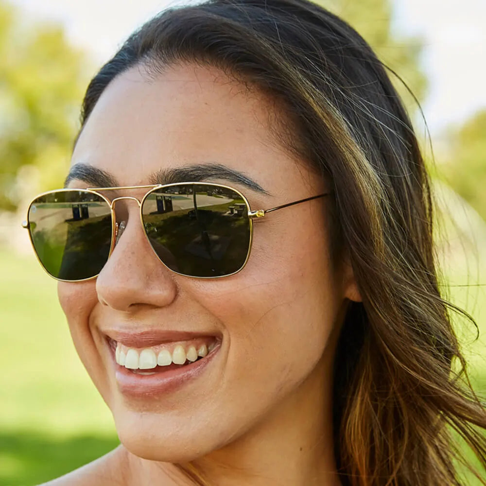Women wearing Gold / Aviator Green Mount Evans Sunglasses
