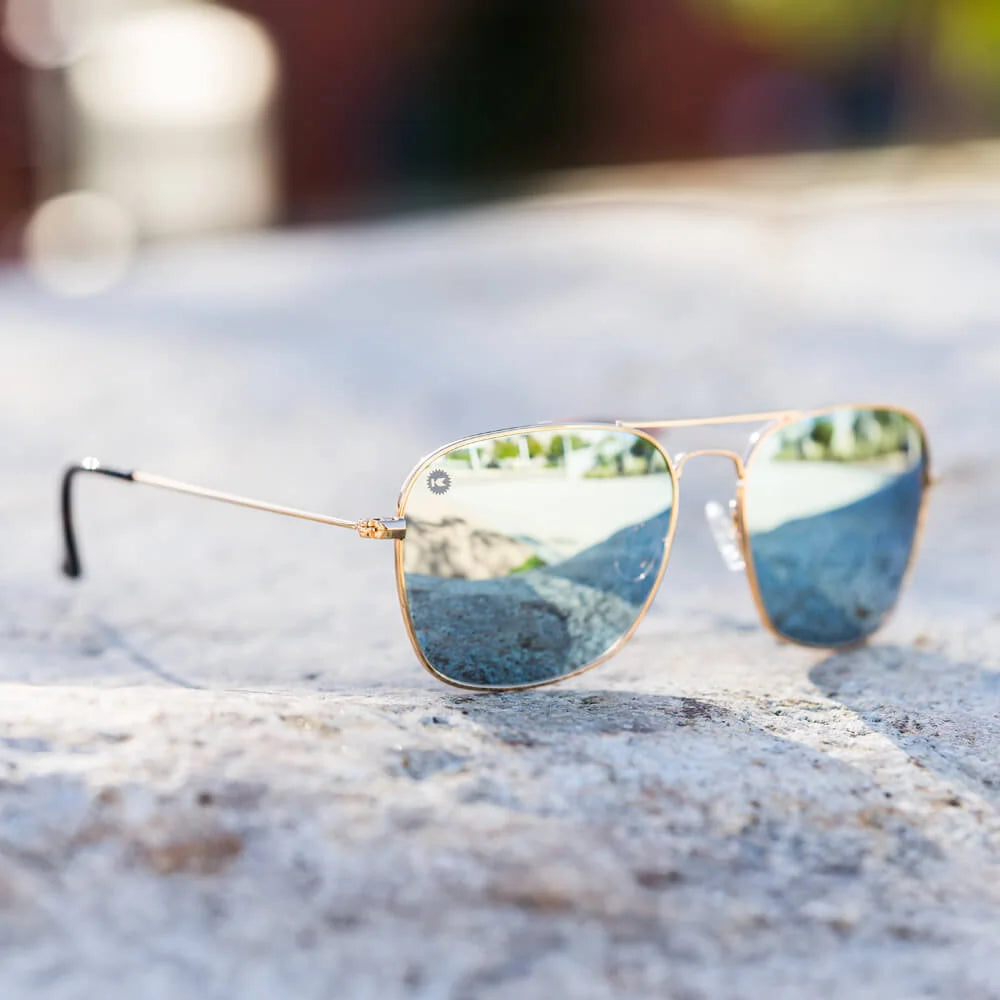 Lifestyle photo of Gold / Sky Blue Mount Evans Sunglasses
