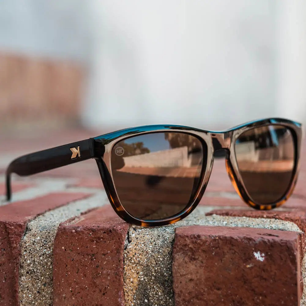 Lifestyle photo of Glossy Black and Tortoise Shell Fade / Amber Premiums Sunglasses
