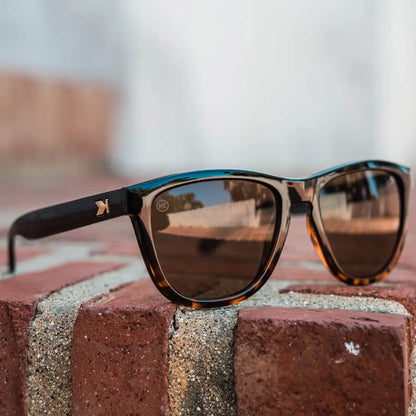 Lifestyle photo of Glossy Black and Tortoise Shell Fade / Amber Premiums Sunglasses
