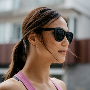 Woman wearing Black on Black 
Premiums Sport sunglasses