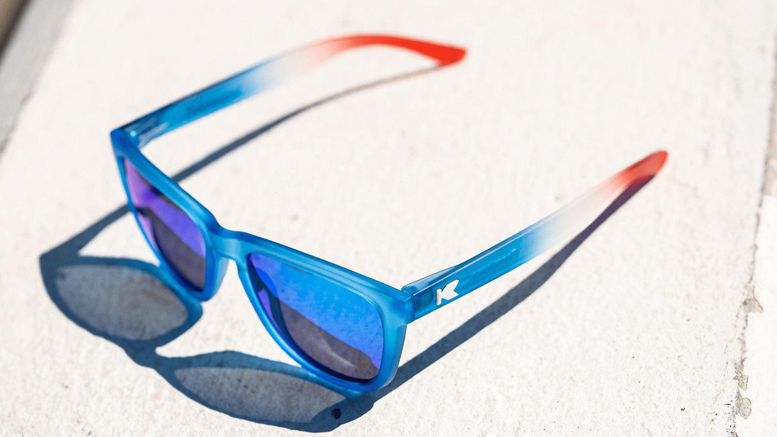 Sunglasses with Blue, Red, and White Frames and Polarized Blue Moonshine Lenses, Lifestyle
