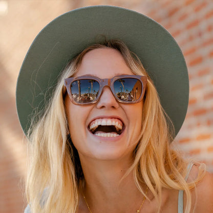 Woman wearing Rose Latte Songbirds sunglasses