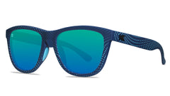 Sunglasses with matte blue frames and polarized green moonshine lenses, threequarter