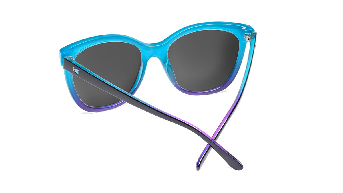 Sunglasses with Glossy Black Exterior and Ice Blue to Lavender Interior and Polarized Snow Opal Lenses. Back