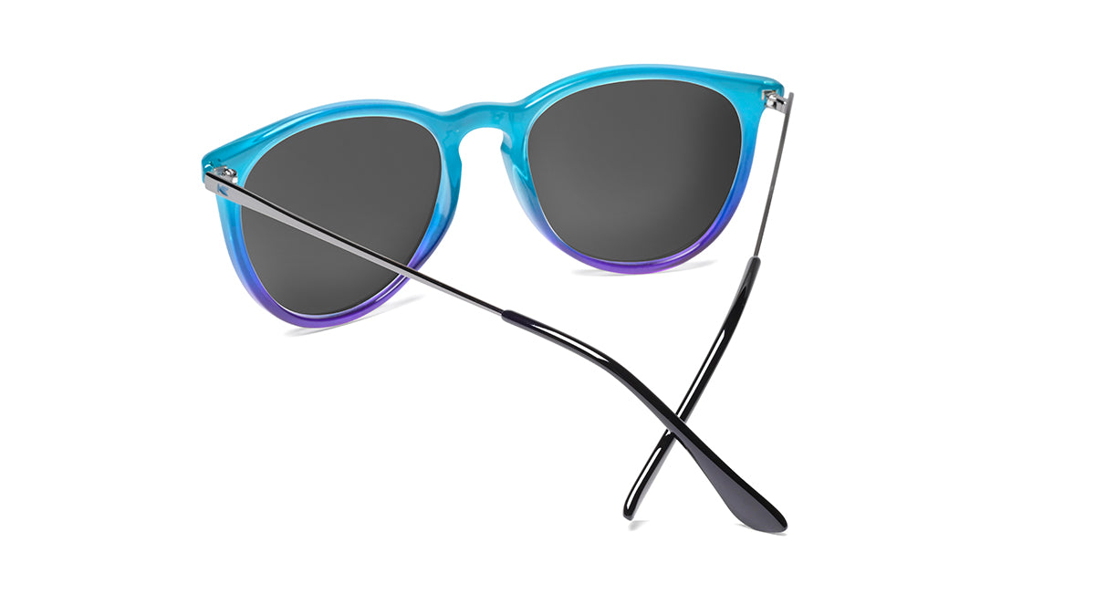 Sunglasses with Glossy Black Exterior and Ice Blue to Lavender Interior and Polarized Snow Opal Lenses. Back