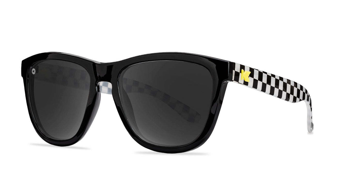 Sunglasses with black and white frames and polarized black smoke lenses