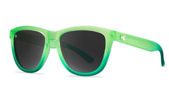 Sunglasses with green fade frames and polarized smoke lenses