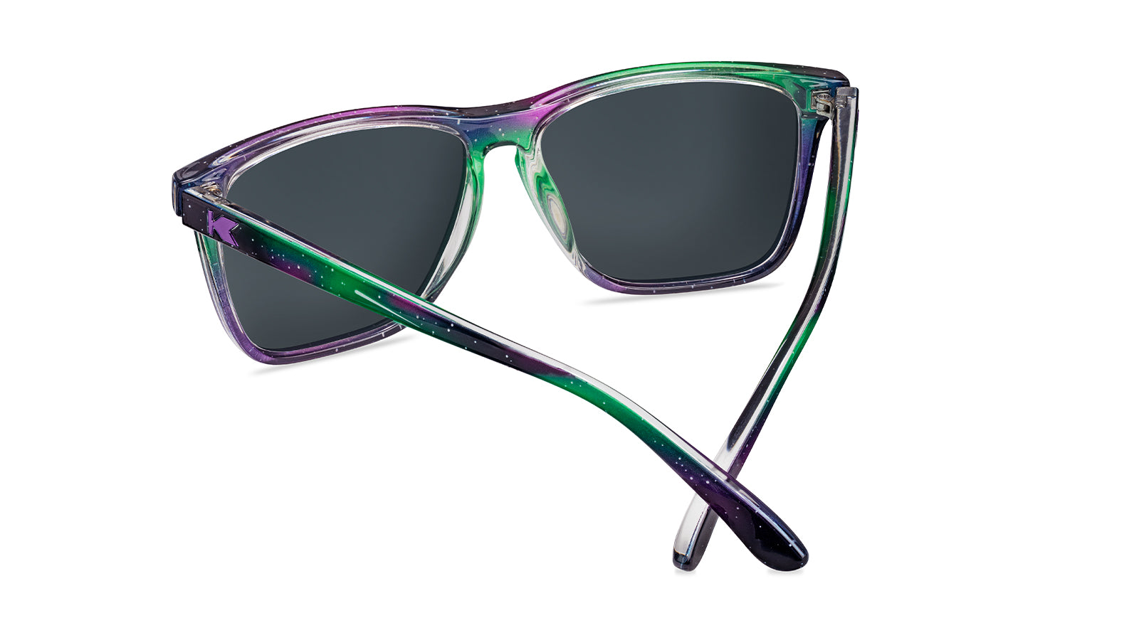 Sunglasses with Green, indigo, and violet streaks across starry sky frames  Polarized northern moonshine lenses Purple K logos