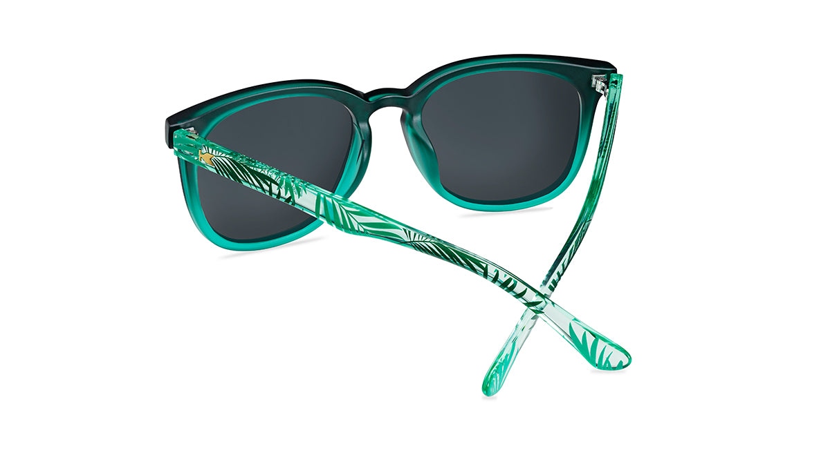 Sunglasses with green fronts, green palm tree arms, and polarized green lenses, back