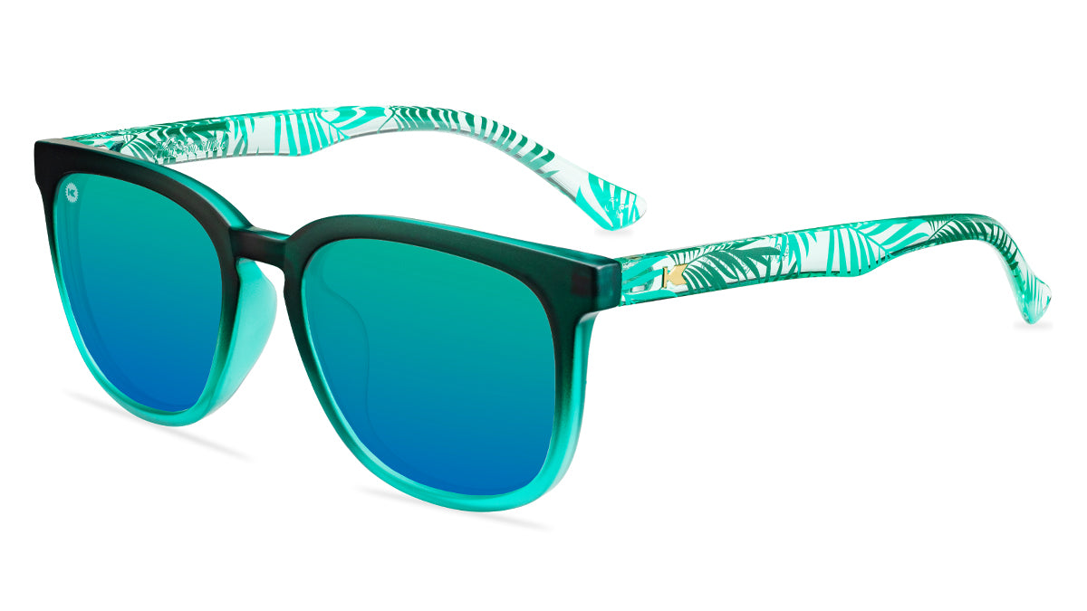 Sunglasses with green fronts, green palm tree arms, and polarized green lenses, flyover