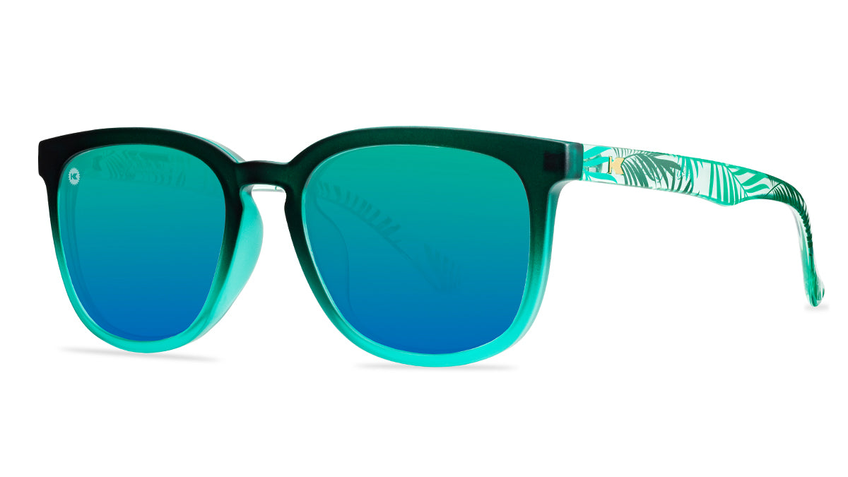 Sunglasses with green fronts, green palm tree arms, and polarized green lenses, threequarter