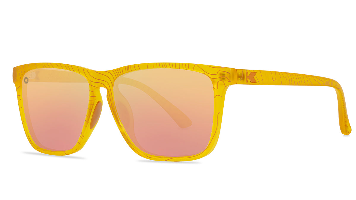 Sunglasses wtih yellow topographic frames and polarized peach lenses, threequarter