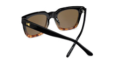 Sunglasses with a glossy black and blonde tortoise shell frame with polarized amber lenses, back
