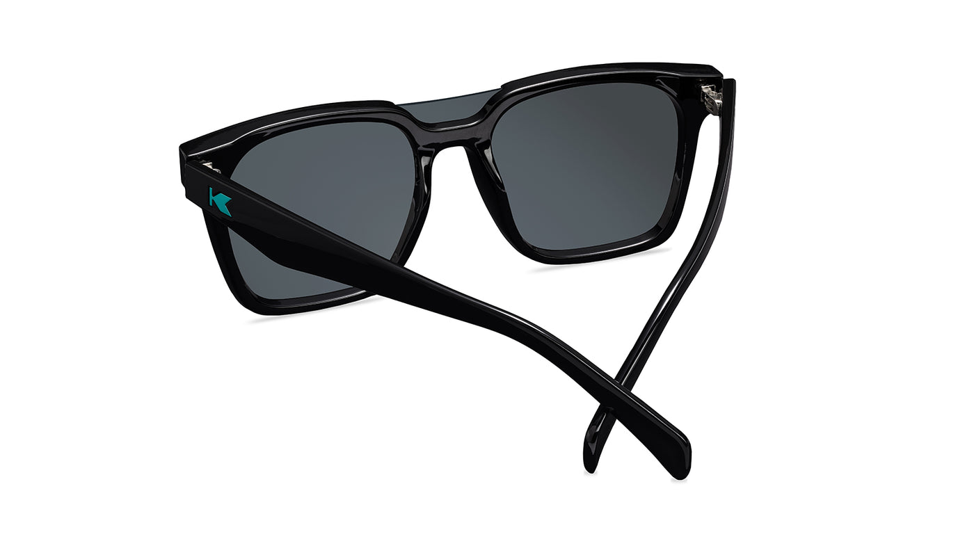 Sunglasses with a black frame with polarized green lenses, back