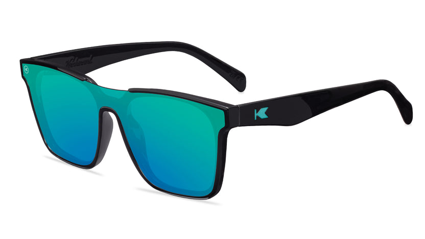 Sunglasses with a black frame with polarized green lenses, flyover