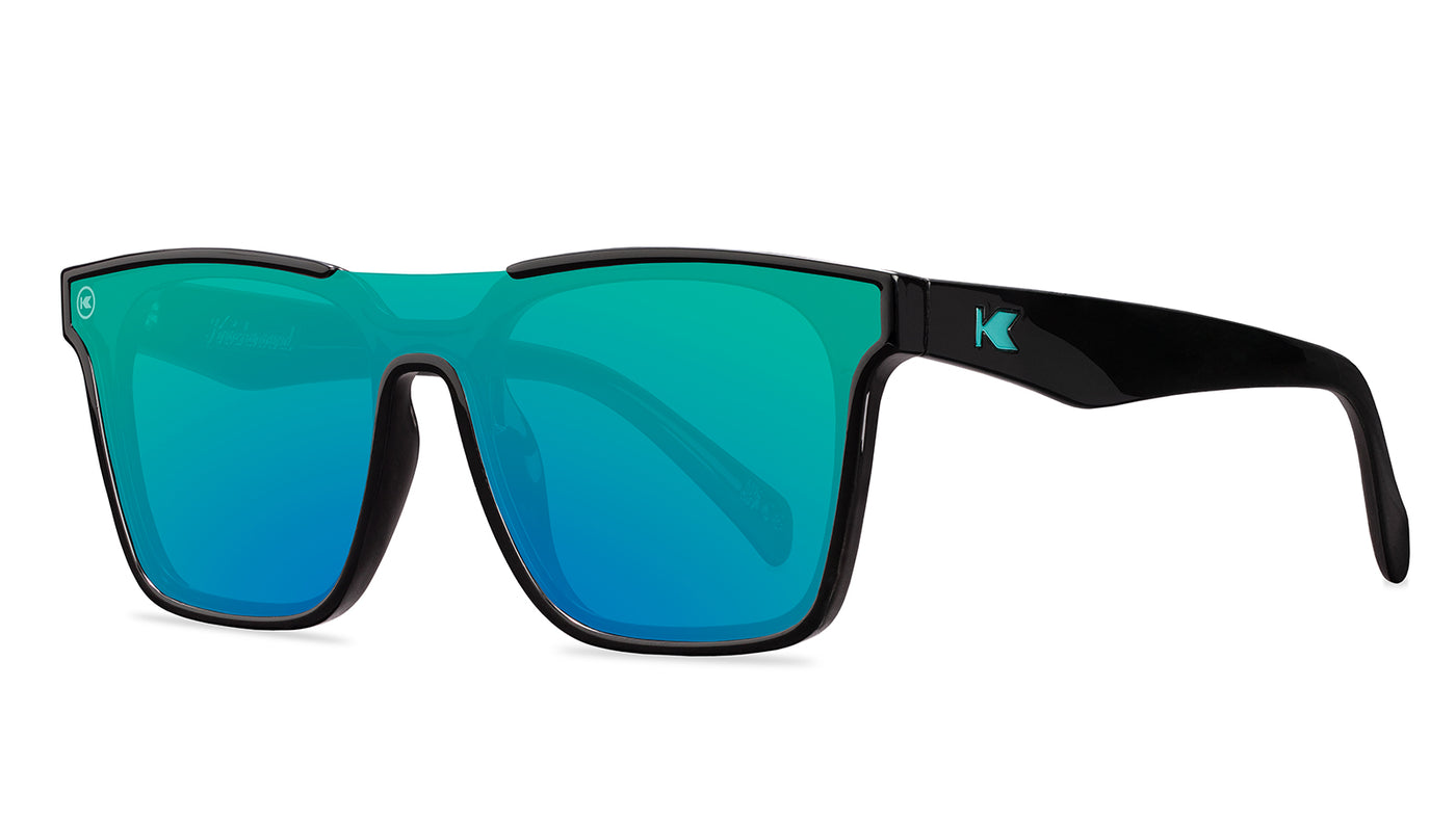Sunglasses with a black frame with polarized green lenses, threequarter
