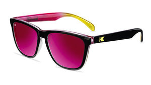 Sunglasses with glossy black frames and polarized pink sunset lenses, flyover