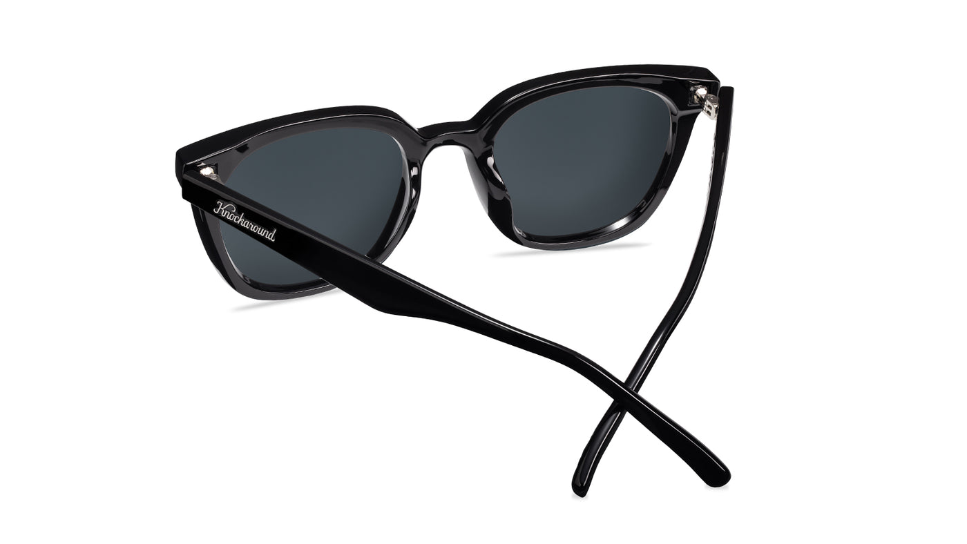 Sunglasses with a black frame with polarized blue lenses, back
