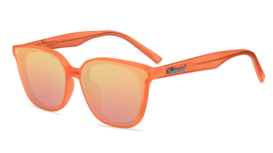 Sunglasses with an orange frame with polarized orange lenses, flyover