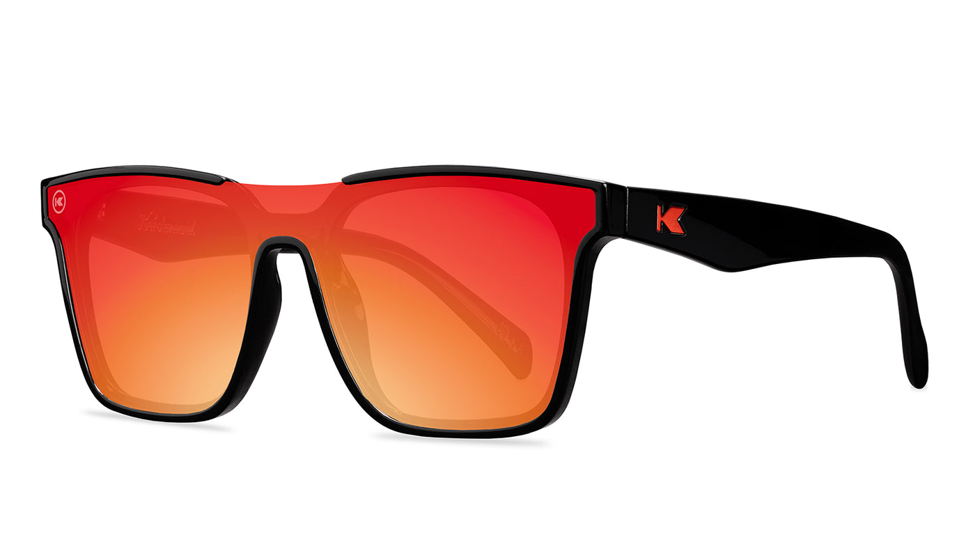 Sunglasses with a black frame with polarized orange lenses, threequarter