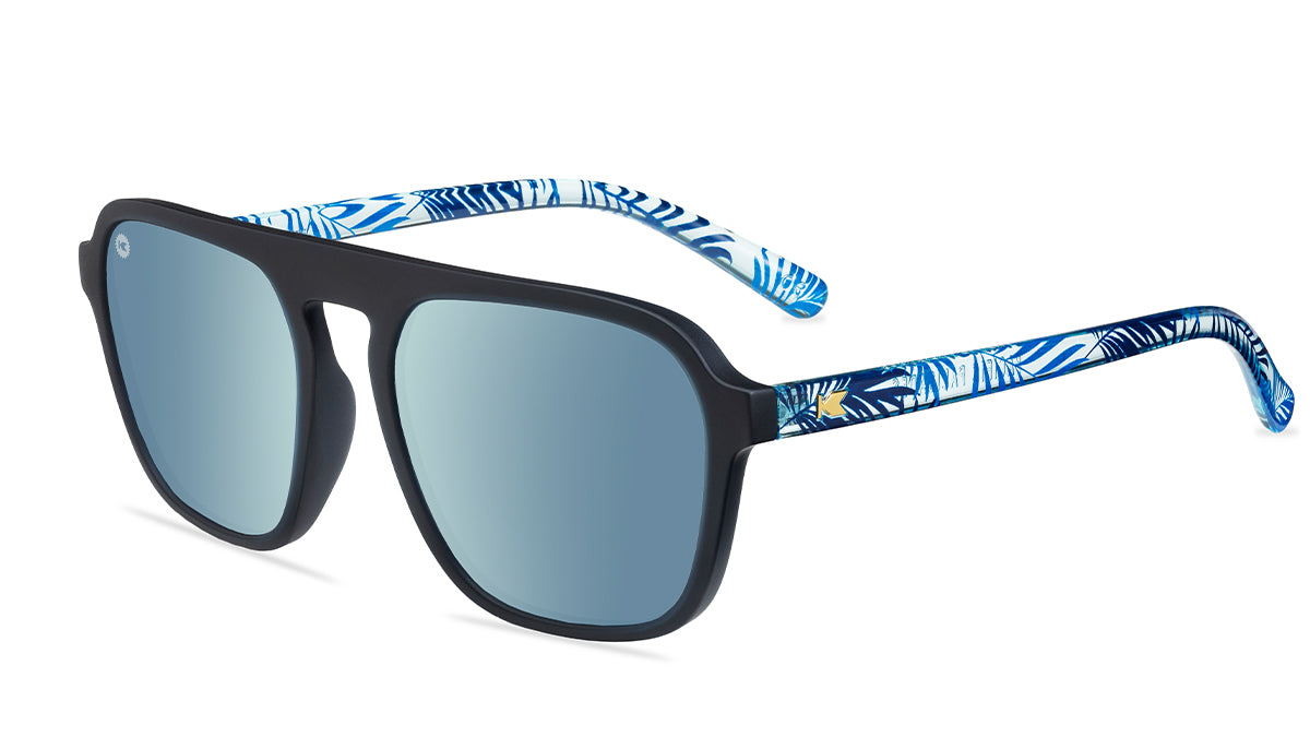 Sunglasses with black fronts, blue palm tree arms and polarized sky blue lenses, flyover