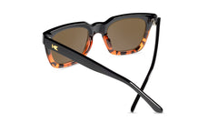 Sunglasses with a glossy black and tortoise shell frame with polarized amber lenses, back