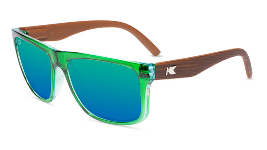 Sunglasses with glossy green fronts, wooden arms and polarized green lenses, flyover