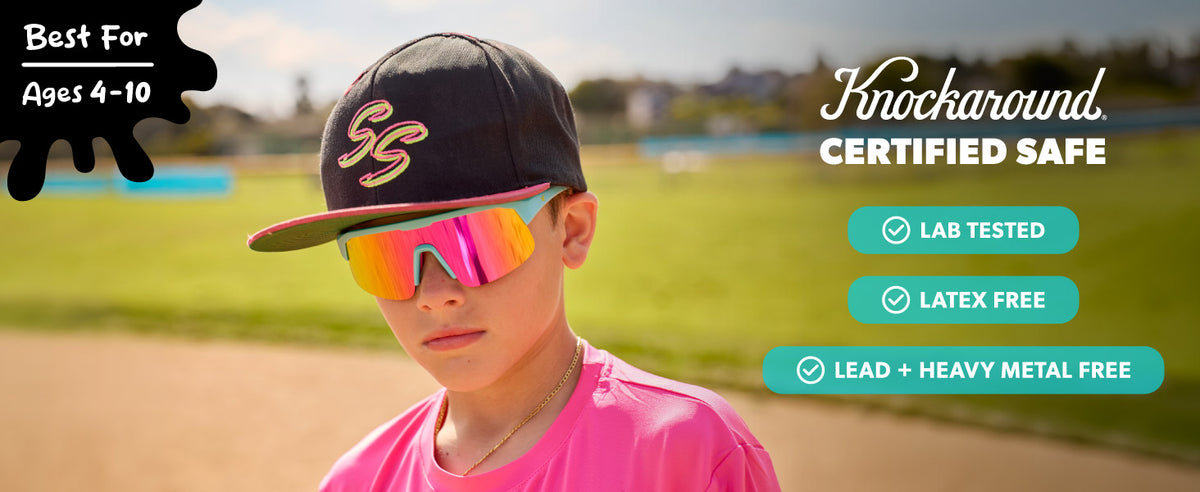 Knockaround Certified Safe. Best for ages 4-10. Lab Tested. Latex Free. Lead + Heavy Metal Free. Boy wearing Wild Card / Pink Sunset Kids Volts Sunglasses