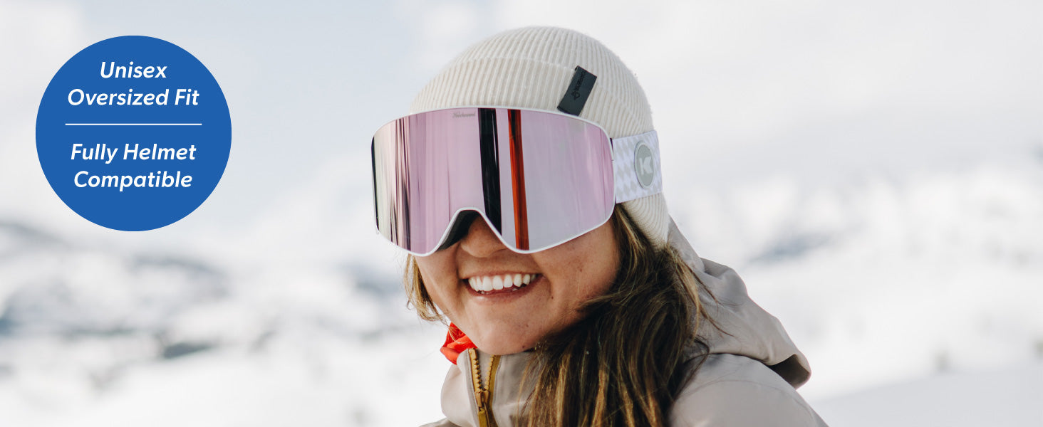 Slingshots Snow Goggles: Fit Guide. Unisex, oversized fit. Full helmet compatible. Photo features a woman in snow gear wearing Slingshots snow goggles