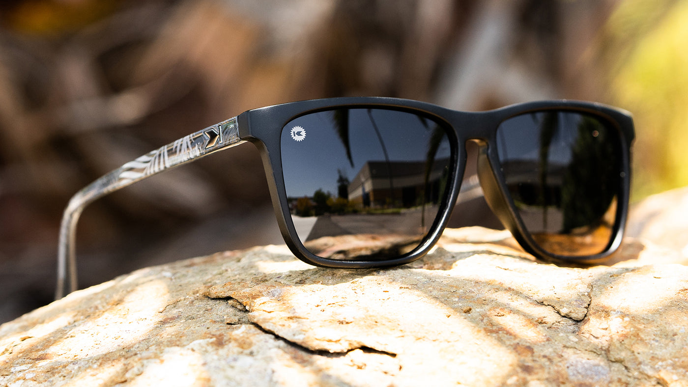 Sunglasses with Black Fronts and Palm Tree Arms and Polarized Smoke Lenses
