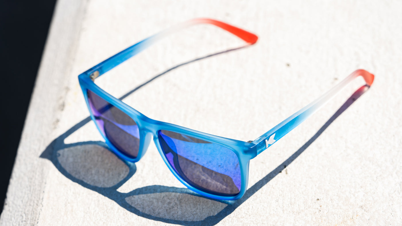 Sunglasses with Blue, White, and Red Frames and Polarized Blue Moonshine Lenses