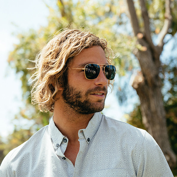 Man wearing  Gold / Aviator Green Mount Evans Sunglasses
