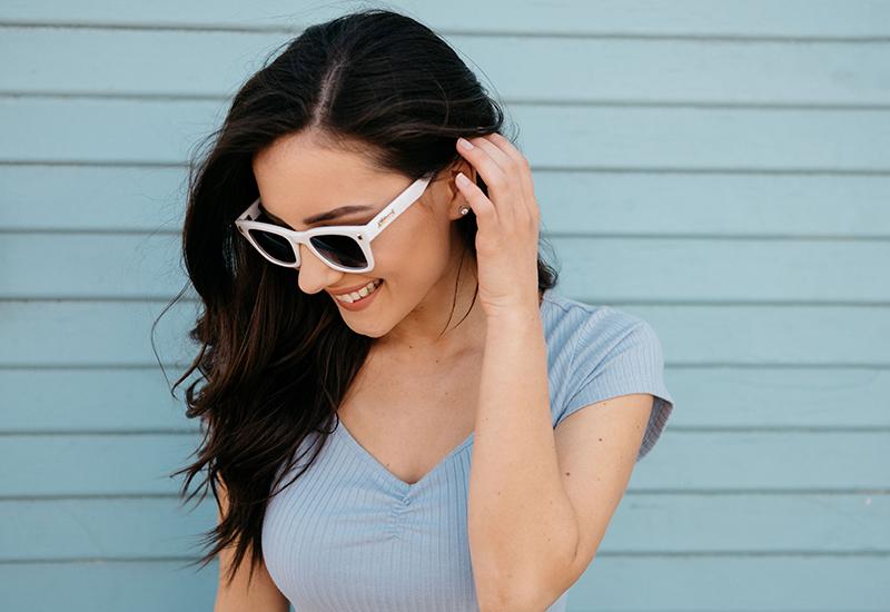 Female model wearing sunglasses with Glossy White Frames and Polarized Smoke Gradient Lenses